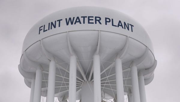 The top of a water tower reads "Flint Water Plant" in bold letters.