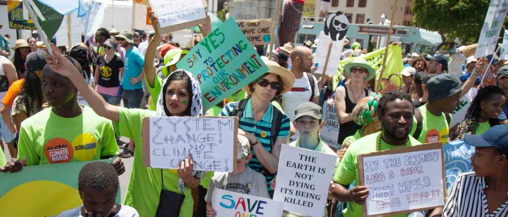 People are holding signs as they march at Keizergracht Street during a protest against 'Climate Change and Global Warming,' in Cape Town, South Africa. Credit: Anadolu Agency