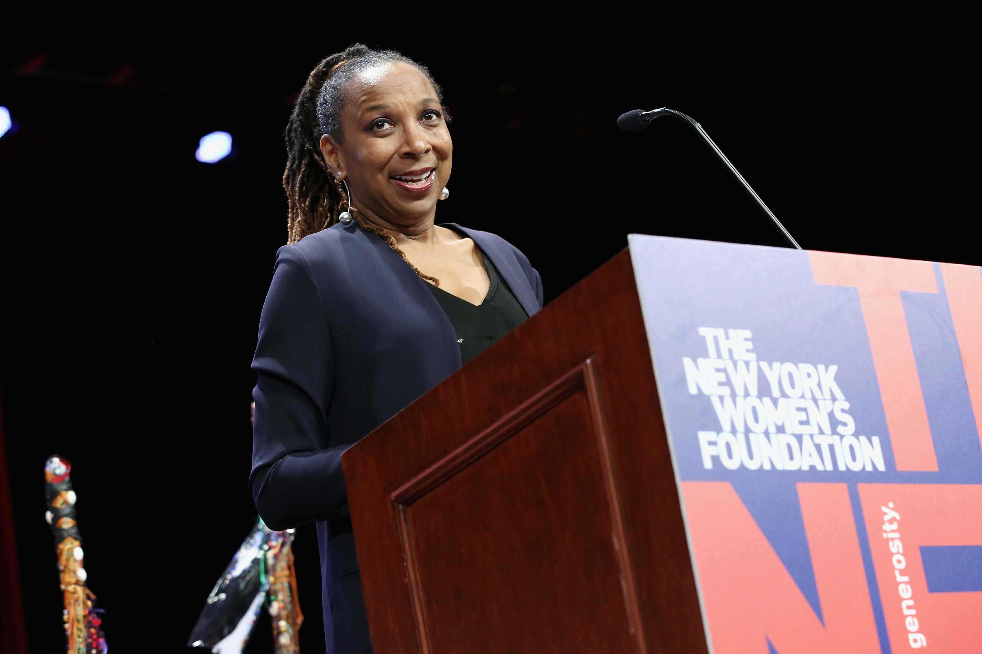 Kimberlé Crenshaw speaks at a podium that is labeled "The New York Women's Foundation"