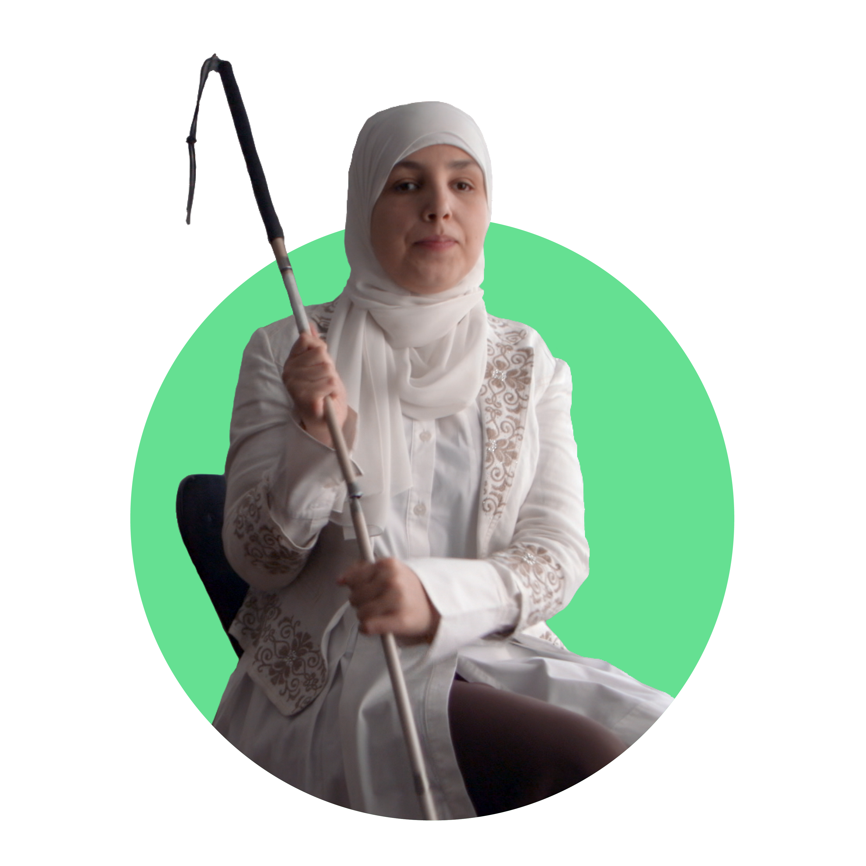 Sara Minkara, a blind Lebanese-American woman, wearing a white headscarf holds her cane with both hands to her right while seated.