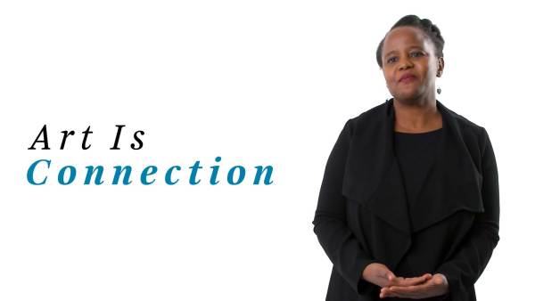 Edwidge Danticat, a black woman, is wearing an oversized black collared sweater over a black top. The phrase "Art Is Connection" appears to her left.