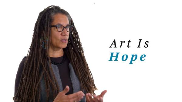 Nikky Finney wears a gray zippered vest over a black long-sleeved crew neck top. The phrase "Art Is Hope" appears to the right.