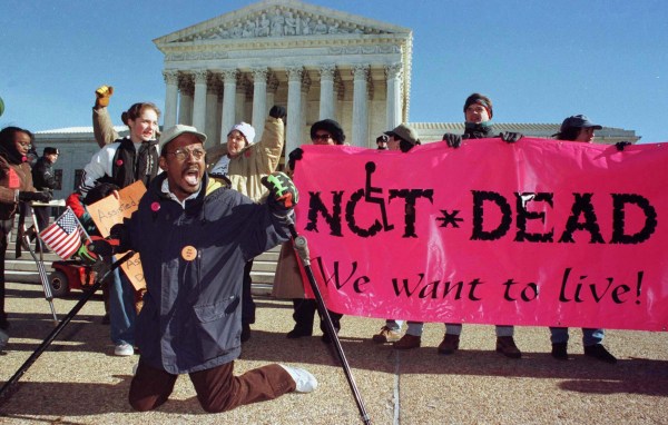 Gregory Dugan of Washington D.C. (L) leads a group of protesters against doctor assisted suicide in front of the U.S. Supreme Court.